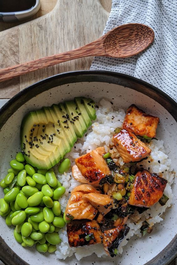 bowl with salmon rice avocado and green beans, good food for homons and hormonal health